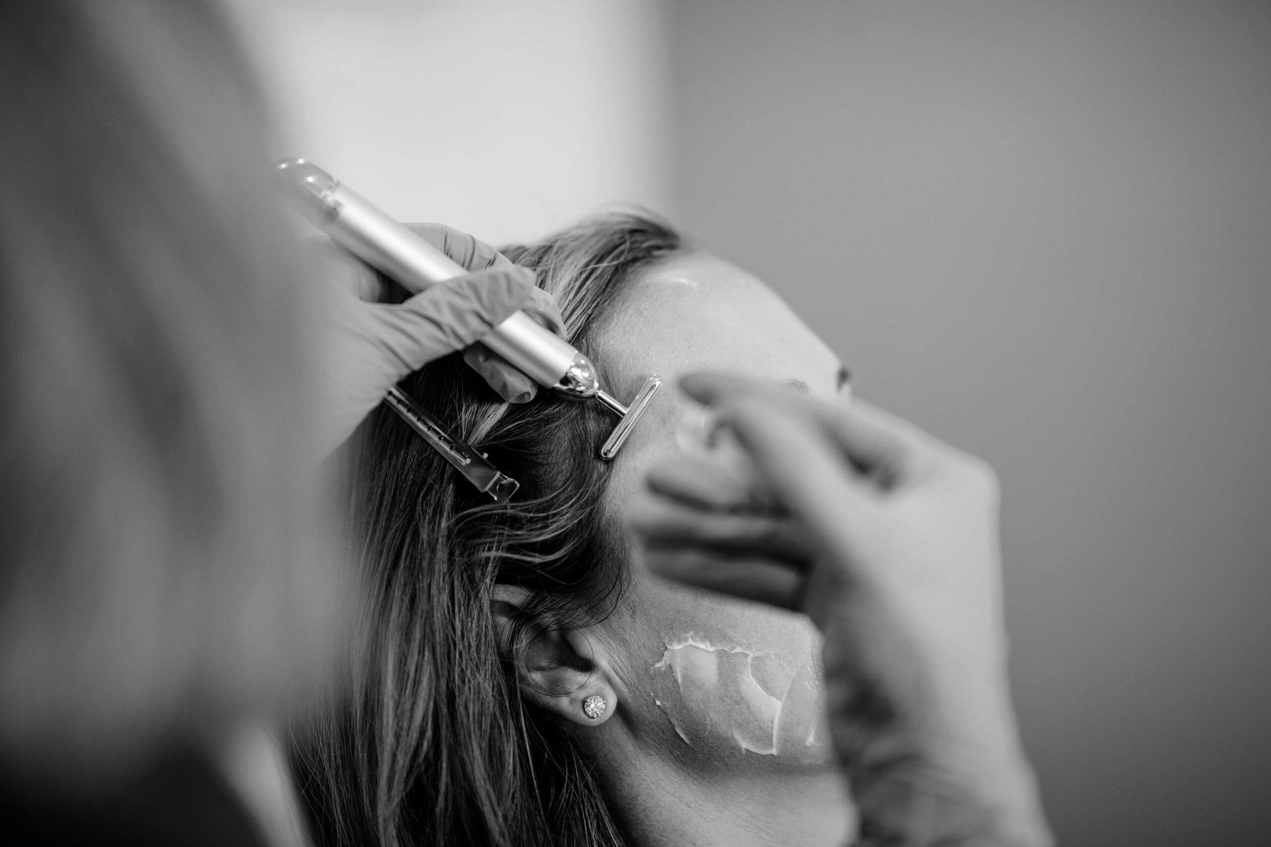 Black and white photo of provider evaluating patient's upper face at Seiff Center