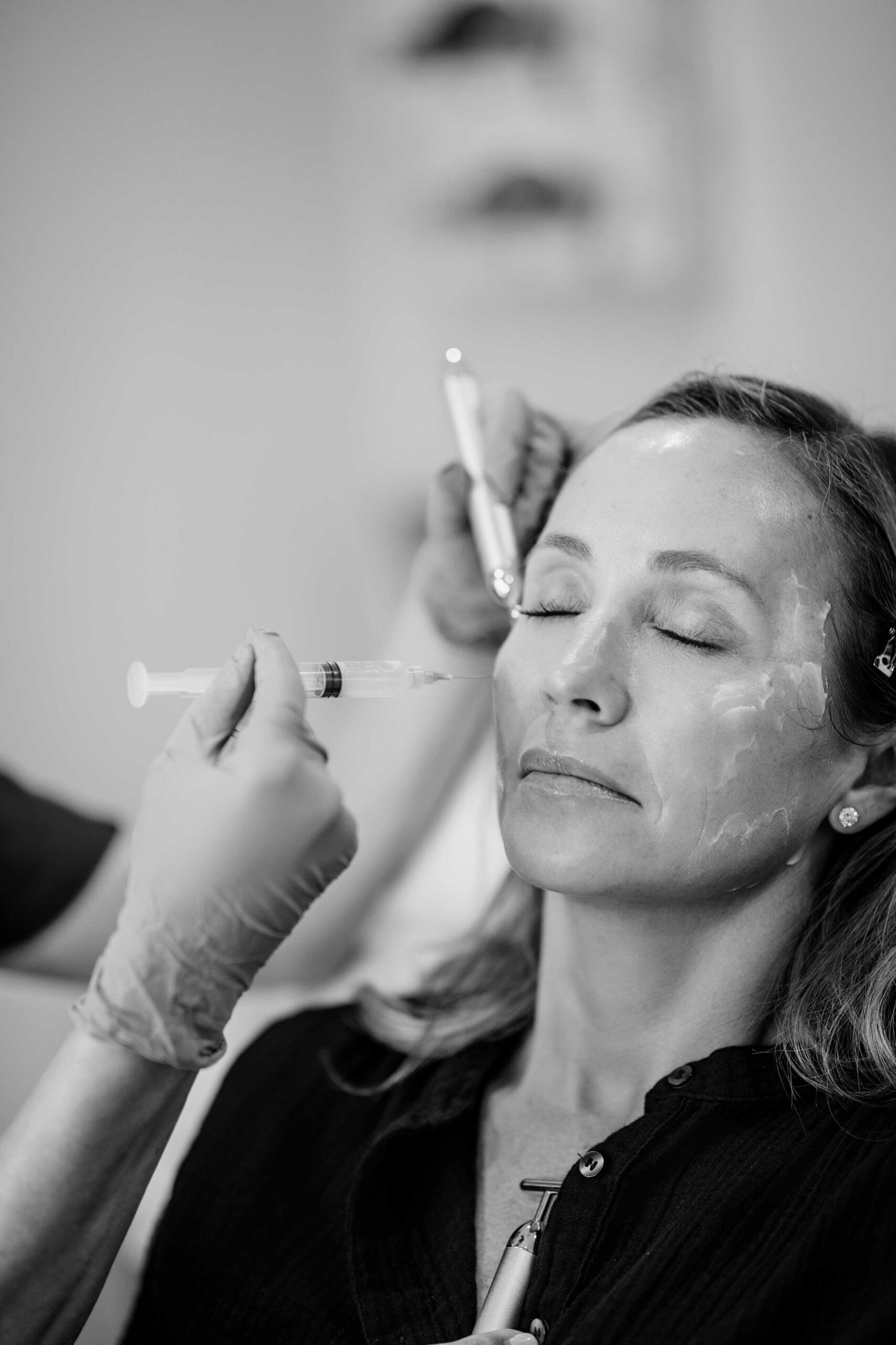 Black and white image of provider assessing patient’s eye structure at Seiff Center