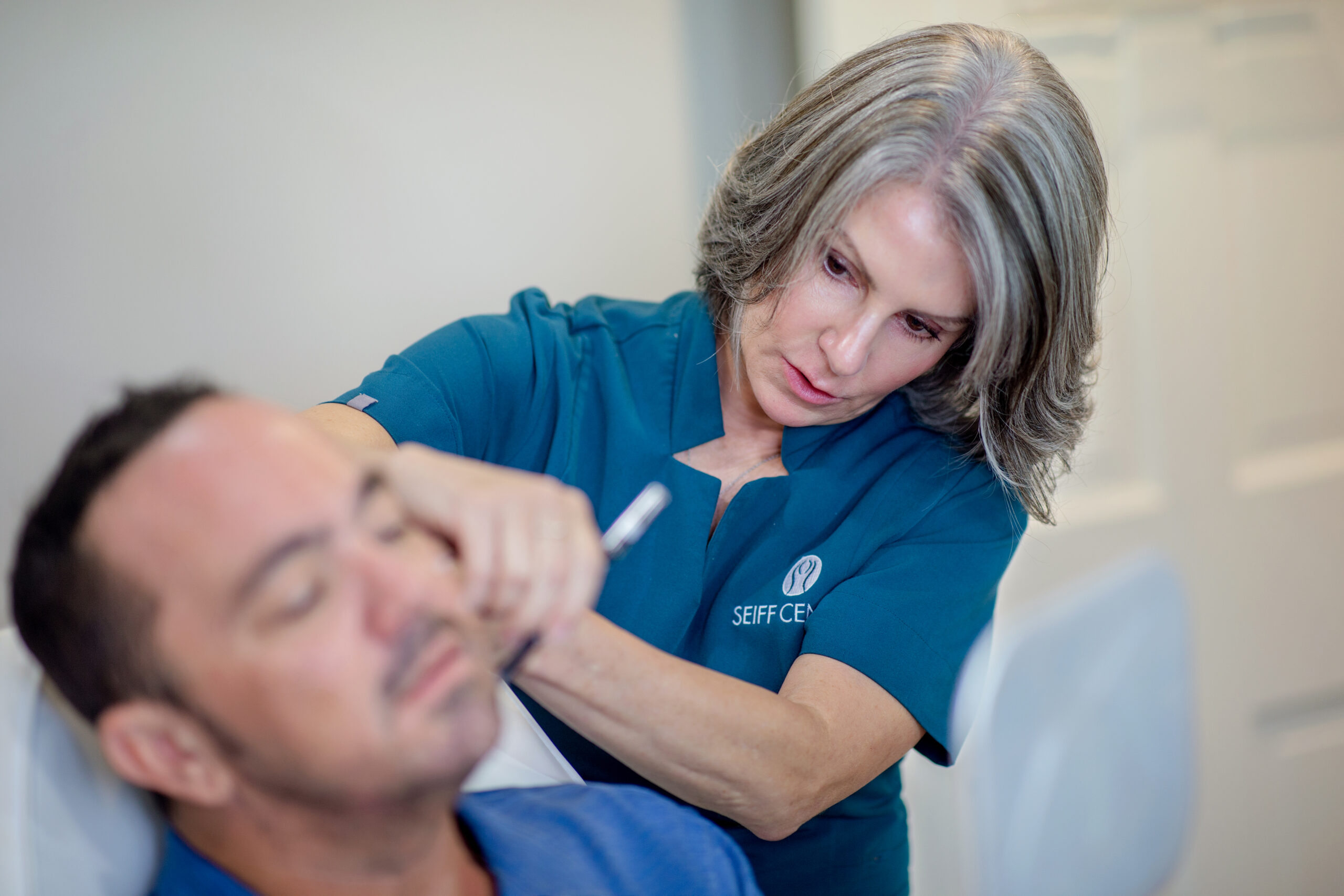 Black and white photo of provider organizing treatment tools at Seiff Center
