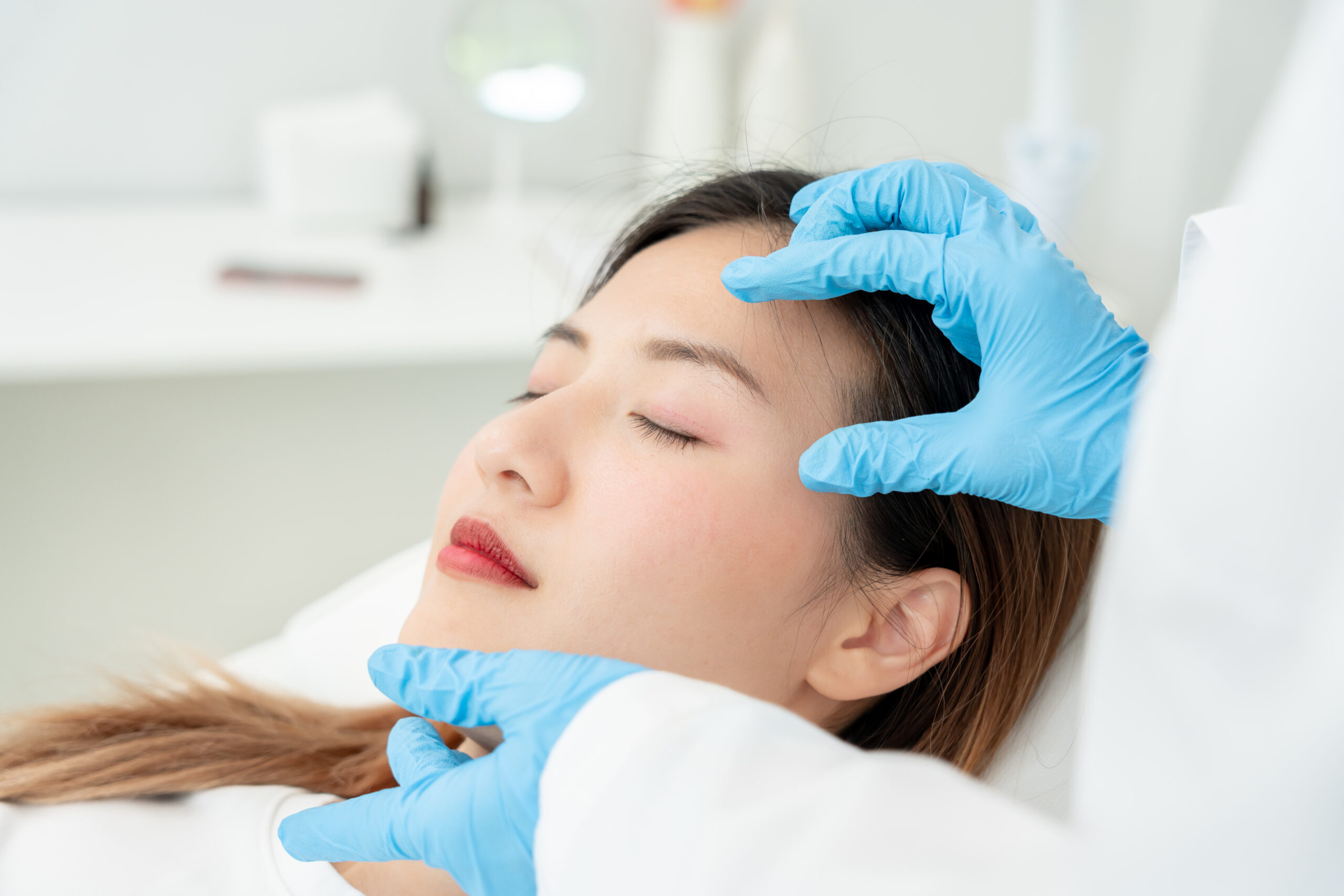 Cosmetic Surgeon touching woman face, surgical procedure at Seiff Center